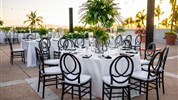 Las Casitas Village at El Conquistador - Venkovní posezení a restaurace v resortu El Conquistador s výhledem na palmy, oceán a západ slunce.